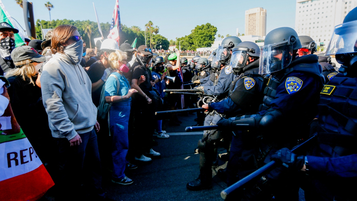 What laws give him authority to send federal troops : NPR